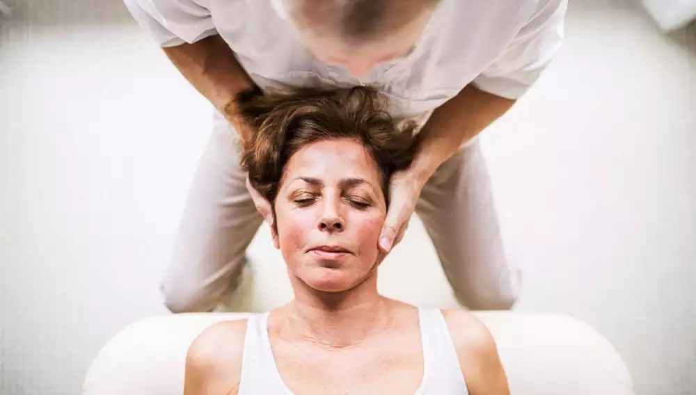 This is an image of a women having her neck adjusted.